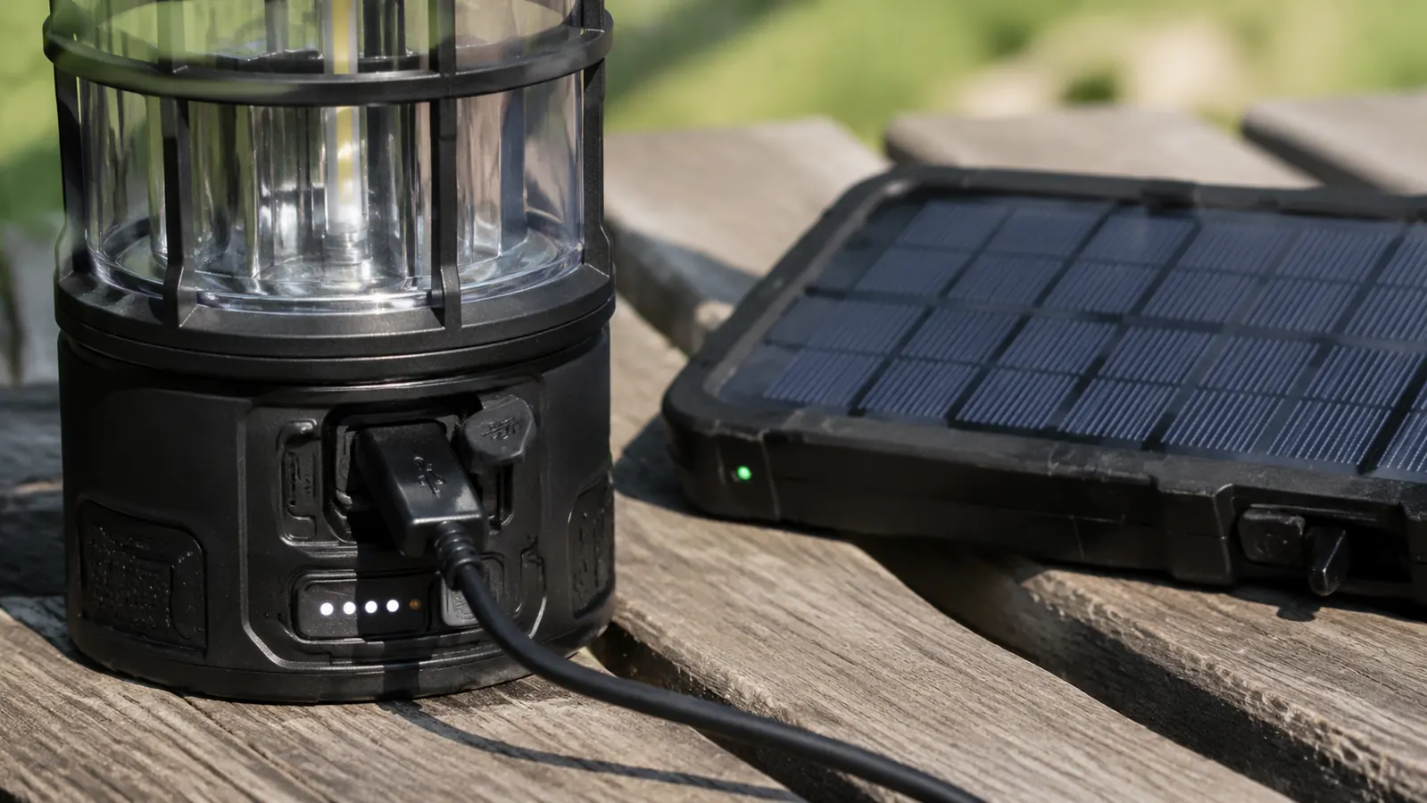 A 20,000mAh power bank next to the Lepro lantern on a picnic table, both showing charge indicators